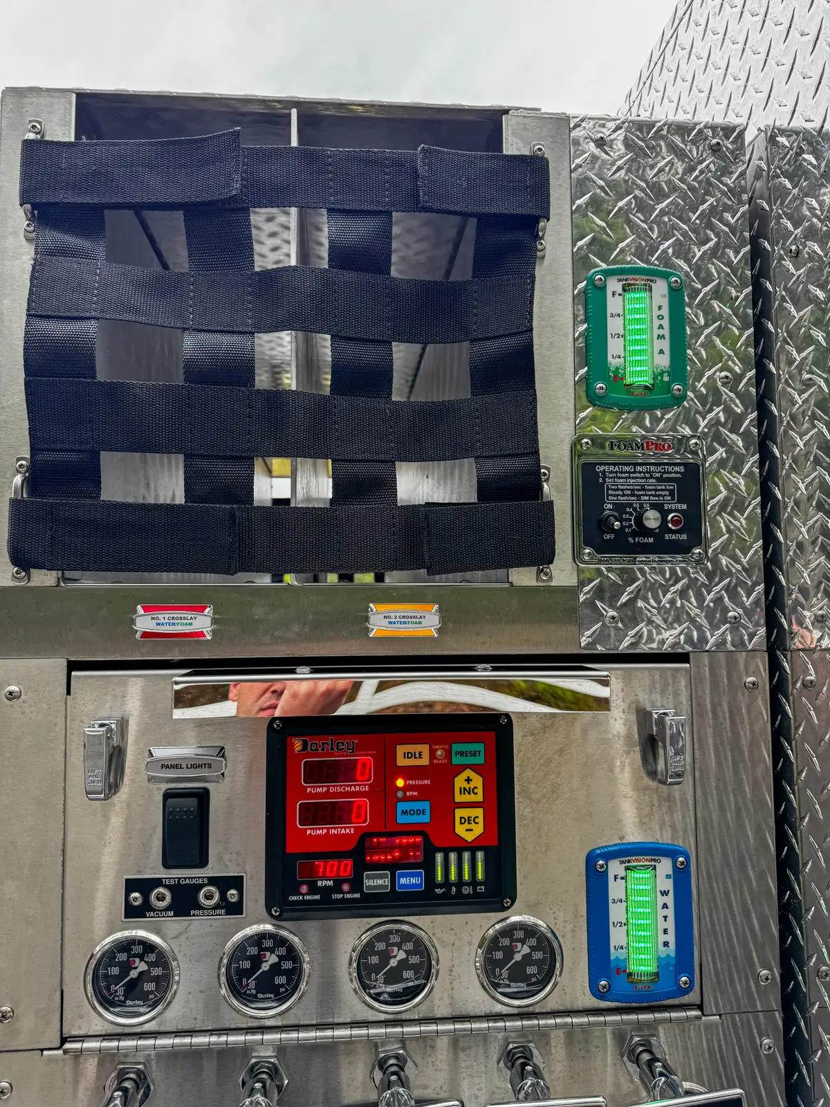 Pump panel close-up with gauge cluster, switches, and labeled connections.